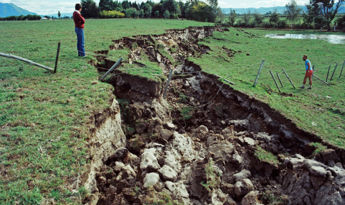 people examine land damge after earthquake