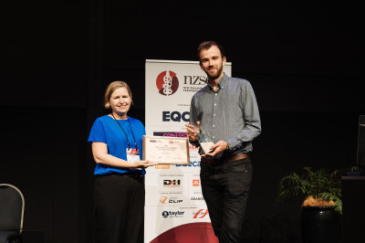 Ben Exton receives the Ivan Skinner Award from EQCs Manager Research Natalie Balfour at the NZSEE conference