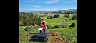 Emeline Wavelet from the University of Otago shows off one of the new seismometers in Southland v2.