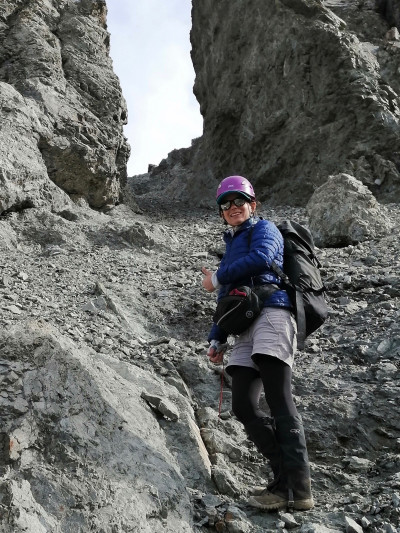 Carolyn Boulton studying greywacke rocks.