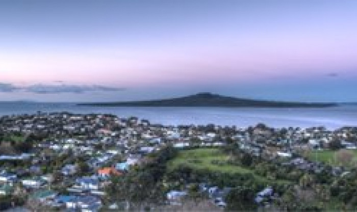 Image looking over city with view of ocean and mountain