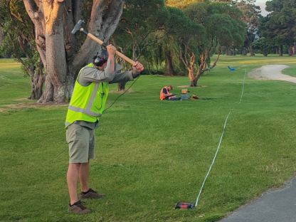 Researchers from the University of Canterbury use a sledgehammer to create vibrations which are recorded by the sensors to determine the composition of the soils below.