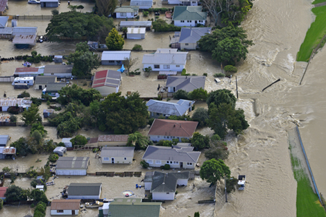 Homes in Edgecumbe are inundated by floodwater following the breach of a river stopbank.