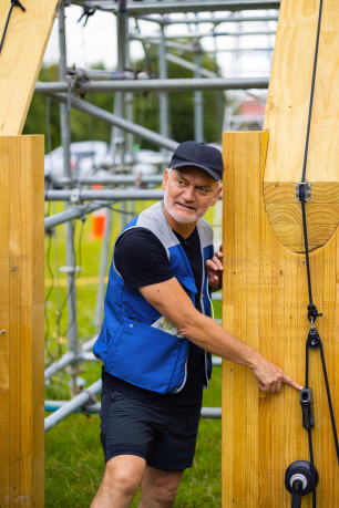 Architect and researcher Professor Anthony Hoete pointing at the structure of the wharenui and explaining how he will earthquake test it.