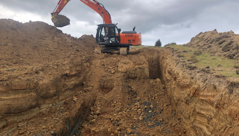 Digger moving earth at Settlement Fault, Catlins